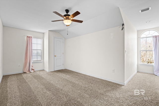 unfurnished room featuring carpet, ceiling fan, and vaulted ceiling