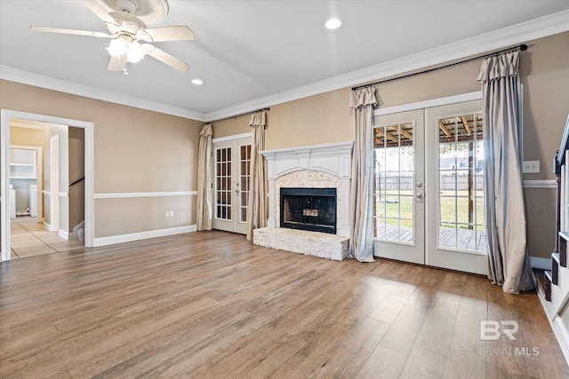 unfurnished living room with light hardwood / wood-style floors, french doors, and crown molding