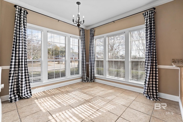 unfurnished dining area with crown molding, light tile patterned flooring, and a chandelier