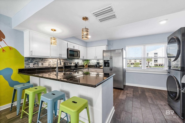 372 E Beach Blvd Unit 14, Gulf Shores, AL 36542 - kitchen featuring stainless steel appliances, stacked washer / drying machine, a sink, and baseboards