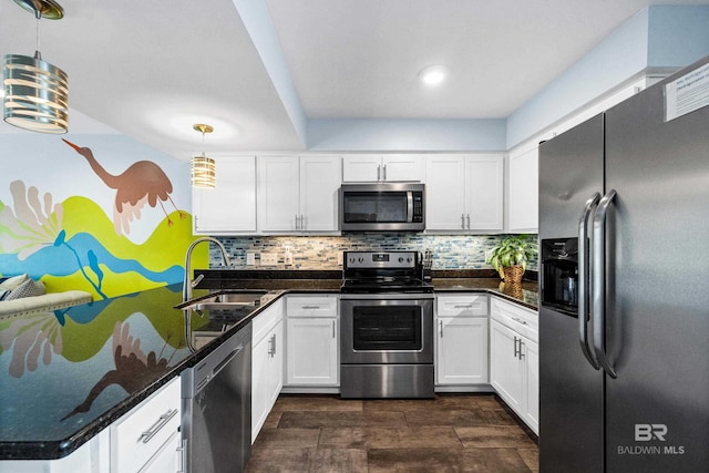 372 E Beach Blvd Unit 14, Gulf Shores, AL 36542 - kitchen featuring stainless steel appliances, a sink, white cabinetry, tasteful backsplash, and pendant lighting