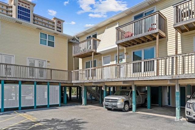 372 E Beach Blvd Unit 14, Gulf Shores, AL 36542 - view of building exterior featuring covered parking and stairway