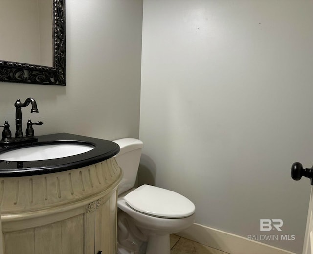 bathroom with tile patterned floors, vanity, and toilet