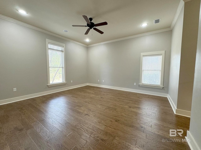 empty room featuring dark hardwood / wood-style floors, ceiling fan, and crown molding