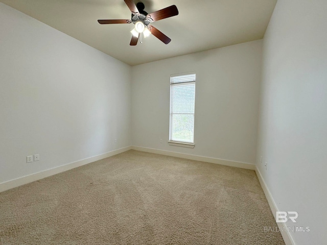 carpeted spare room with ceiling fan