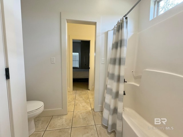 bathroom with tile patterned floors, toilet, and walk in shower