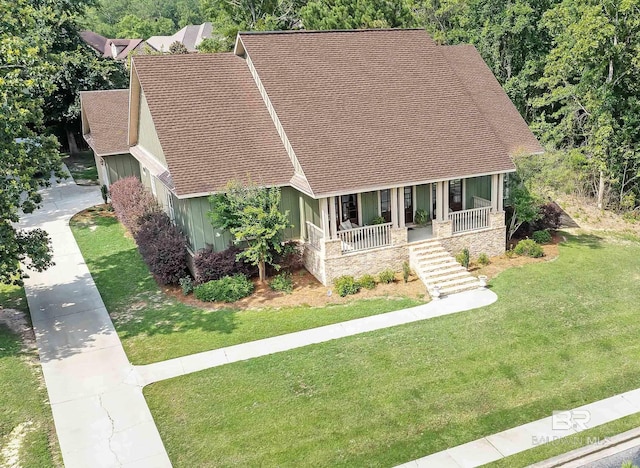 view of front of house with a front yard and a porch