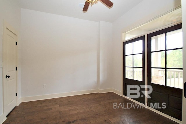 spare room featuring ceiling fan and dark wood-type flooring