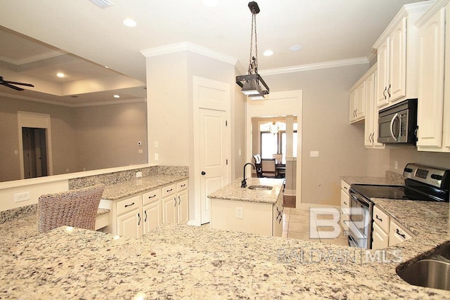 kitchen with sink, ceiling fan, light stone countertops, appliances with stainless steel finishes, and a kitchen island