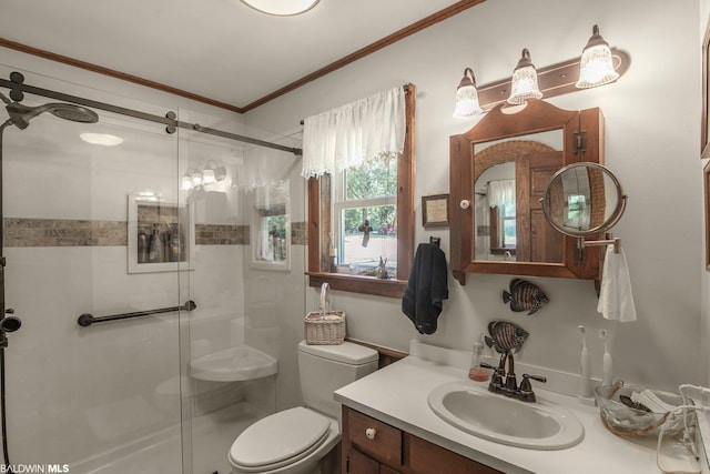 bathroom featuring a shower with shower door, crown molding, toilet, and large vanity