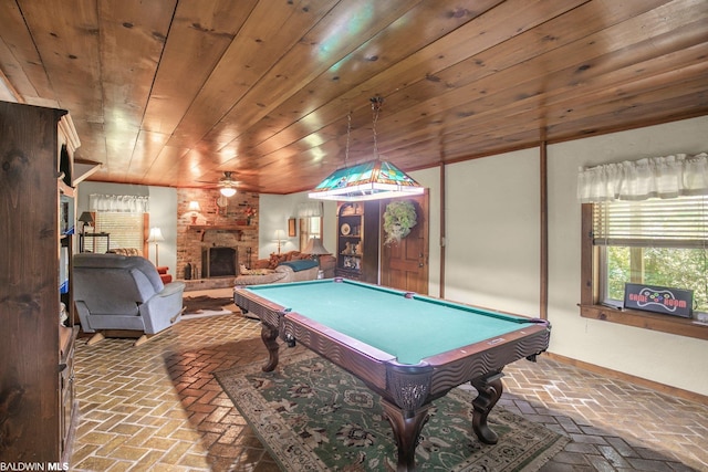 playroom featuring a stone fireplace, pool table, wooden ceiling, and ceiling fan