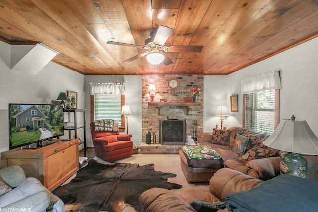 carpeted living room featuring ceiling fan, a brick fireplace, brick wall, and wood ceiling