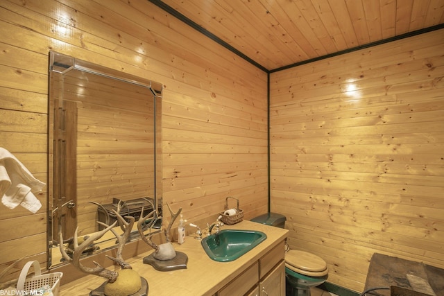 bathroom featuring wooden ceiling, vanity, wood walls, and toilet