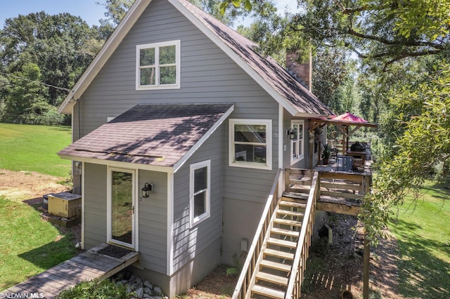 rear view of house with a yard