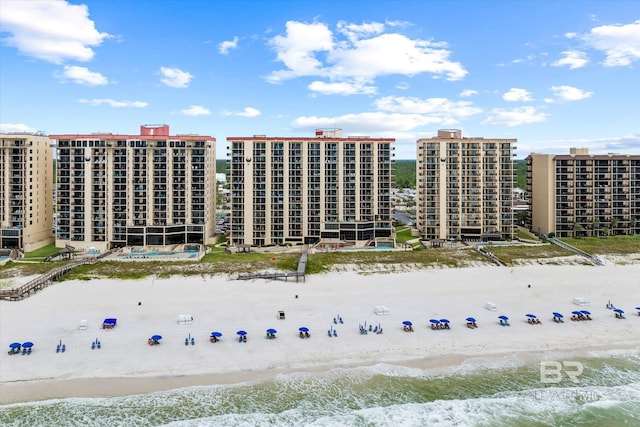 view of property featuring a view of the beach and a water view