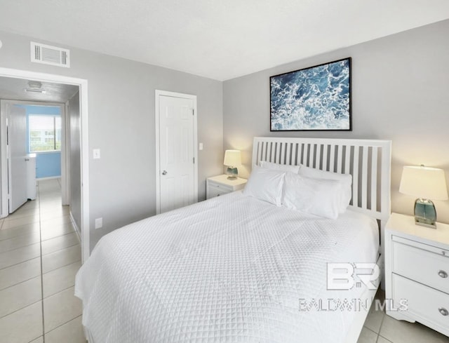 bedroom with light tile patterned floors and visible vents