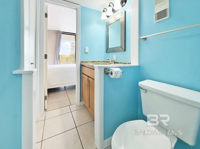 bathroom with tile patterned flooring, toilet, vanity, and visible vents