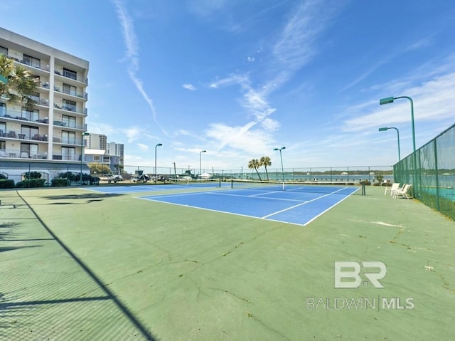 view of sport court featuring fence