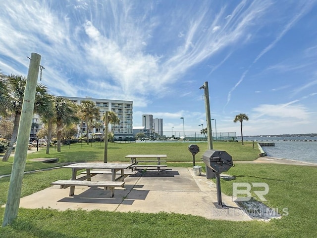 view of community featuring a yard and a water view