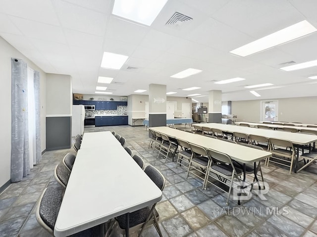 dining space featuring visible vents and a paneled ceiling