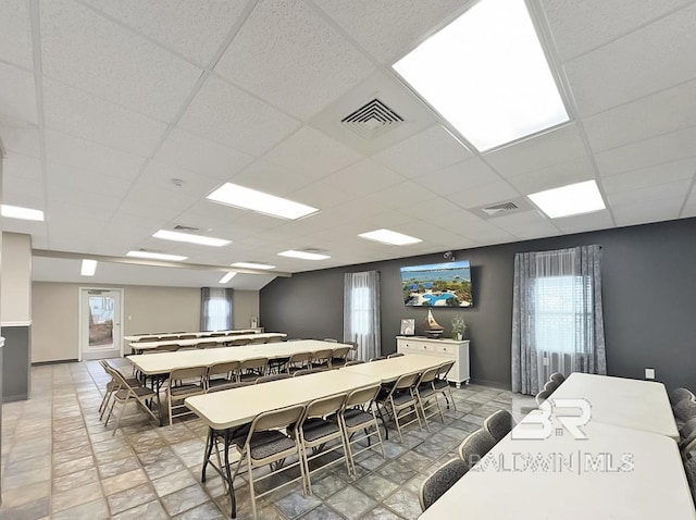 dining space with visible vents and a paneled ceiling