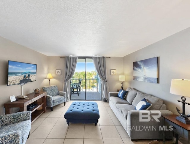 living room with tile patterned floors and a textured ceiling