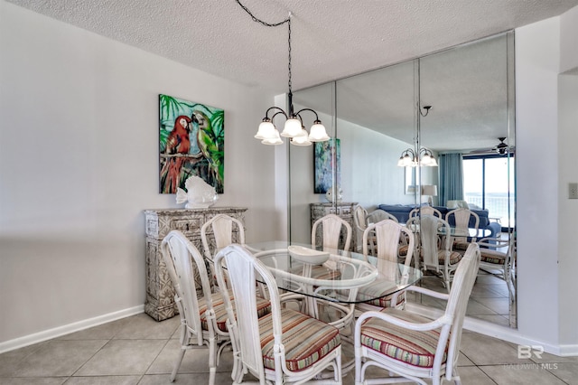 24770 Perdido Beach Blvd Unit 402, Orange Beach, AL 36561 - tiled dining space with a chandelier, a textured ceiling, and baseboards