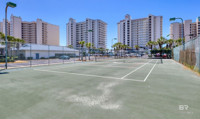 24770 Perdido Beach Blvd Unit 402, Orange Beach, AL 36561 - view of tennis court featuring fence and a view of city
