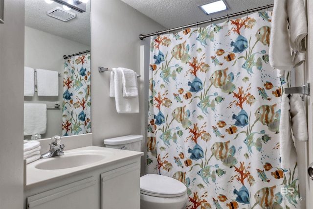 24770 Perdido Beach Blvd Unit 402, Orange Beach, AL 36561 - bathroom featuring a textured ceiling, toilet, vanity, and a shower with curtain