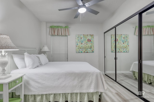 24770 Perdido Beach Blvd Unit 402, Orange Beach, AL 36561 - bedroom with wood finished floors, a closet, a ceiling fan, and baseboards