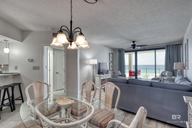 24770 Perdido Beach Blvd Unit 402, Orange Beach, AL 36561 - dining space with a textured ceiling, ceiling fan, and a chandelier