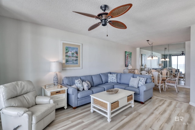 24770 Perdido Beach Blvd Unit 402, Orange Beach, AL 36561 - living area with a ceiling fan, a chandelier, a textured ceiling, and light wood-type flooring