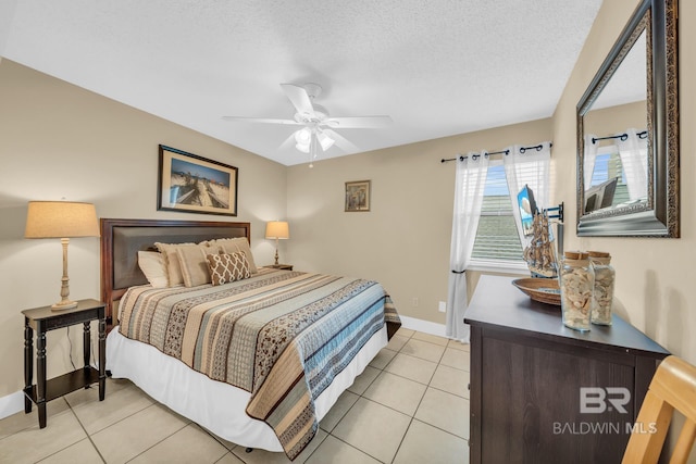 952 W Beach Blvd Unit 106, Gulf Shores, AL 36542 - bedroom featuring light tile patterned floors, a textured ceiling, a ceiling fan, and baseboards