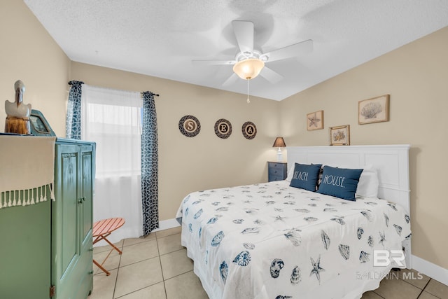 952 W Beach Blvd Unit 106, Gulf Shores, AL 36542 - bedroom featuring light tile patterned flooring, ceiling fan, a textured ceiling, and baseboards