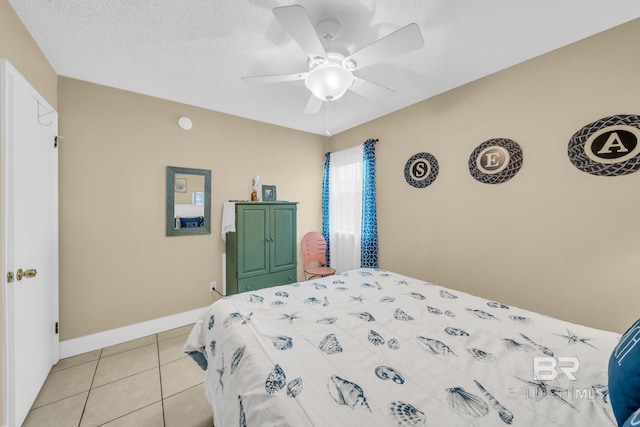 952 W Beach Blvd Unit 106, Gulf Shores, AL 36542 - bedroom featuring light tile patterned floors, ceiling fan, baseboards, and a textured ceiling