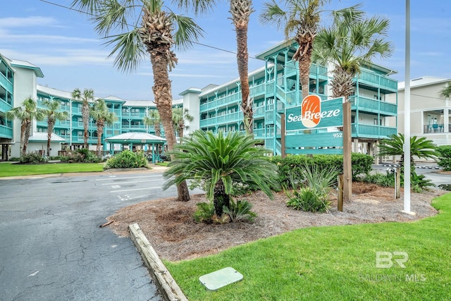 952 W Beach Blvd Unit 106, Gulf Shores, AL 36542 - view of building exterior with uncovered parking