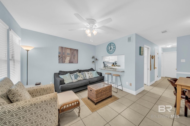 living room with light tile patterned floors and ceiling fan