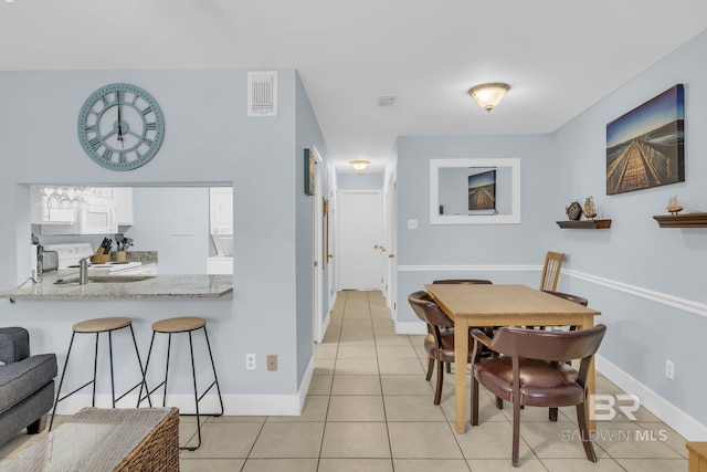 952 W Beach Blvd Unit 106, Gulf Shores, AL 36542 - dining room with light tile patterned floors and baseboards