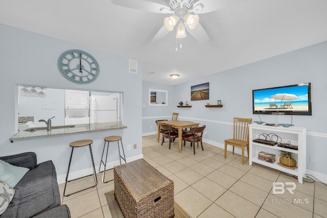 952 W Beach Blvd Unit 106, Gulf Shores, AL 36542 - living room with light tile patterned floors, ceiling fan, and baseboards