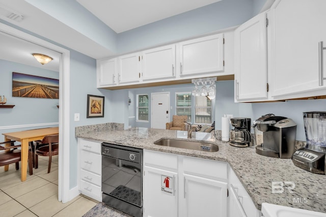 952 W Beach Blvd Unit 106, Gulf Shores, AL 36542 - kitchen featuring black dishwasher, a sink, white cabinets, light tile patterned floors, and light stone countertops