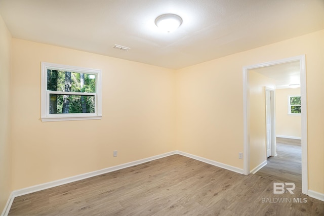 109 Palmer St, Brewton, AL 36426 - unfurnished room featuring visible vents, baseboards, wood finished floors, and a healthy amount of sunlight