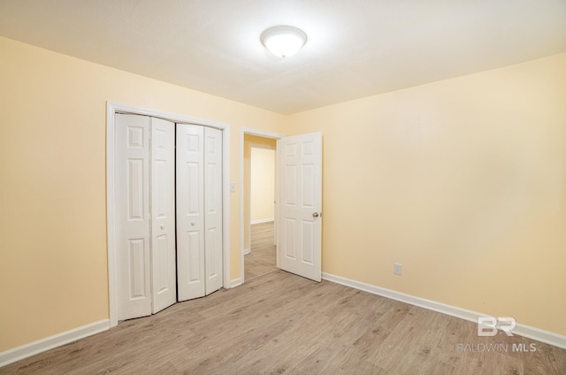 109 Palmer St, Brewton, AL 36426 - unfurnished bedroom featuring light wood-style flooring, a closet, and baseboards