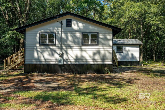 109 Palmer St, Brewton, AL 36426 - view of property exterior featuring a yard and stairway
