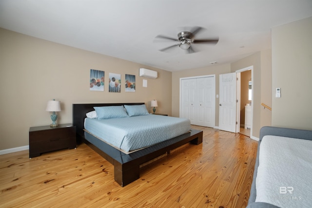 bedroom with a closet, light wood-type flooring, a wall mounted air conditioner, baseboards, and ceiling fan