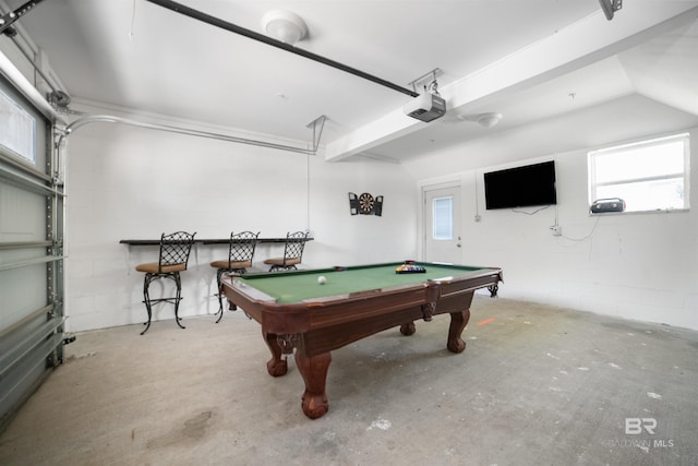 playroom featuring concrete block wall, unfinished concrete flooring, billiards, plenty of natural light, and a garage