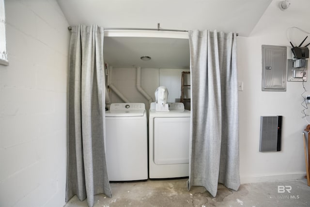 clothes washing area with visible vents, electric panel, concrete block wall, laundry area, and washer and clothes dryer