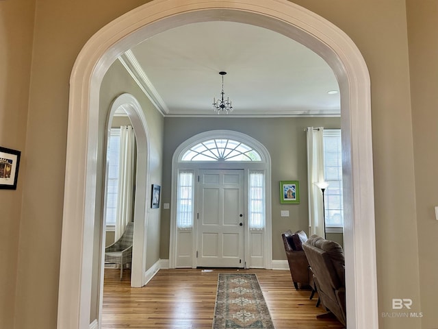 foyer entrance featuring hardwood / wood-style flooring and ornamental molding