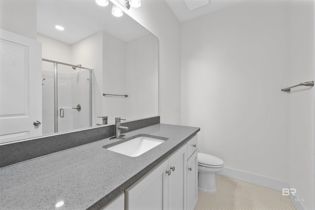 full bathroom featuring toilet, vanity, baseboards, a shower stall, and tile patterned floors