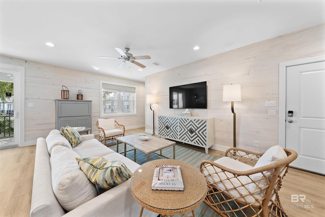 living room featuring a healthy amount of sunlight, recessed lighting, and light wood-style floors