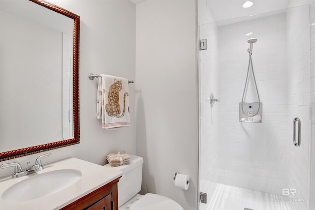 bathroom featuring vanity, a stall shower, and toilet